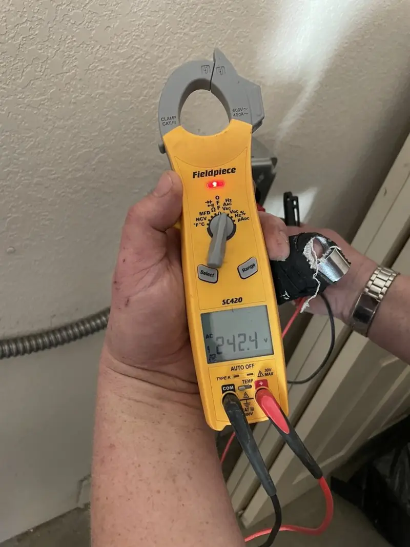 Voltage testing with clamp meter during Outlet Installation in Southeast Arcadia